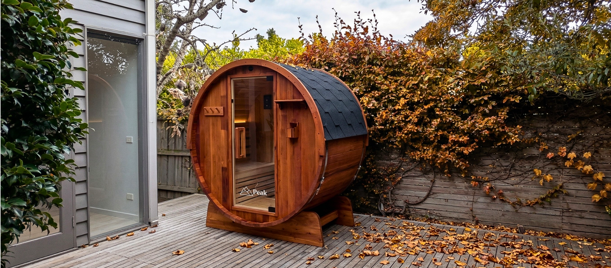 eliza traditional barrel sauna in the backyard during autumn season