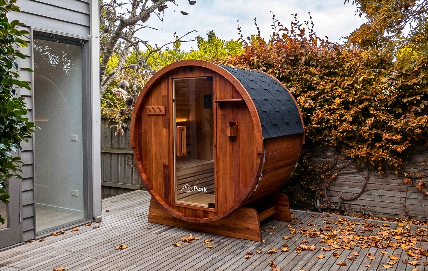 eliza traditional barrel sauna in the backyard during autumn season