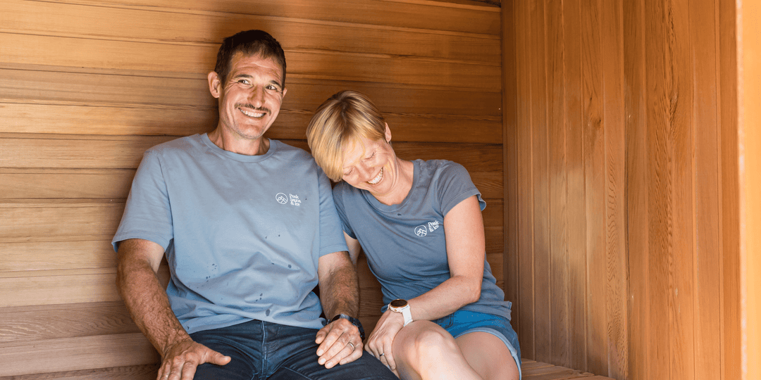 man and woman sitting and smiling in sauna by peak sauna and ice in melbourne