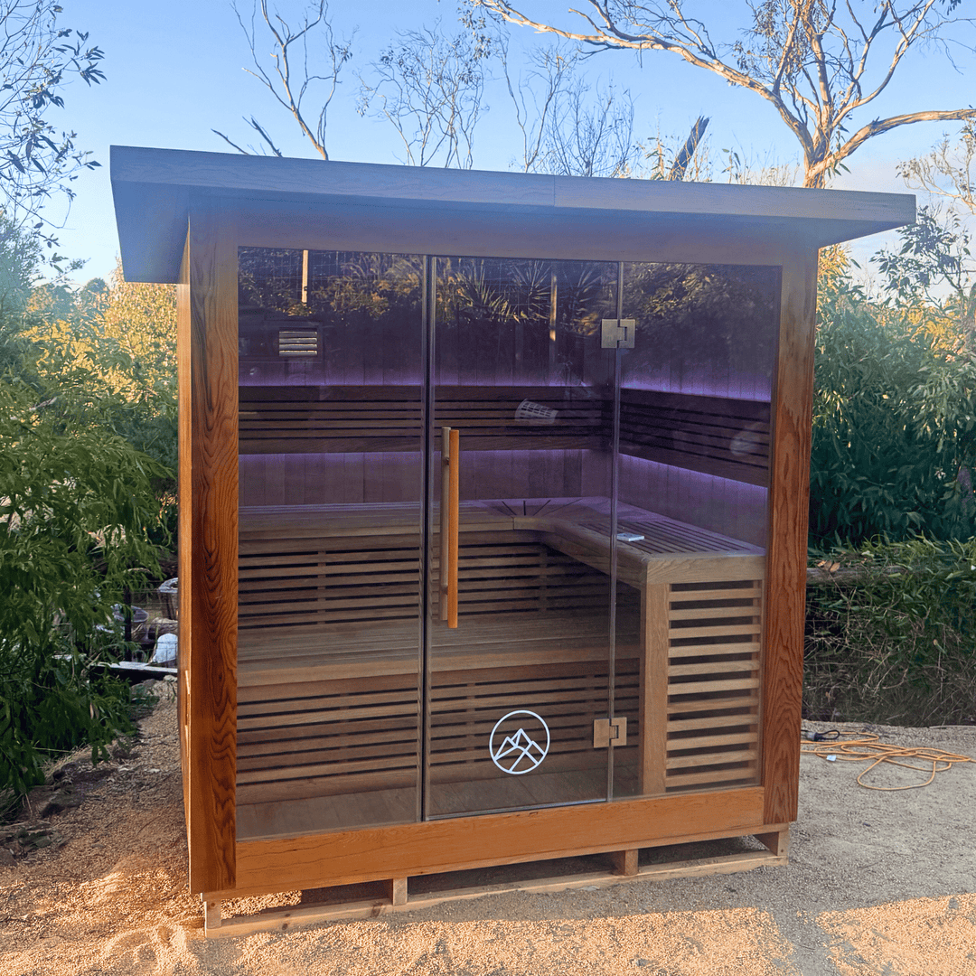 the macedon sauna by peak sauna and ice installed outdoors surrounded by trees